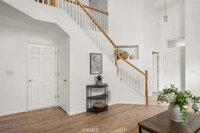 a view of entryway and hall with wooden floor