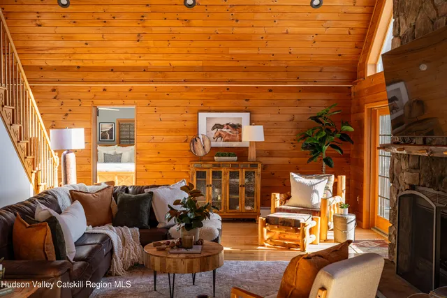 a view of a patio with dining table and chairs with wooden floor