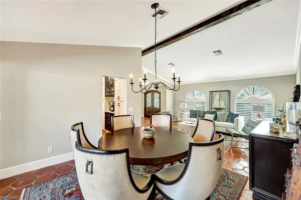 a view of a dining room with furniture and window