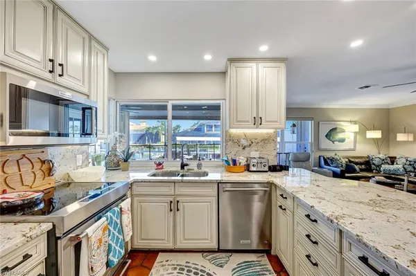 a kitchen with a sink stove and cabinets