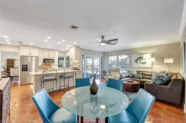 a view of a dining room with furniture a chandelier and wooden floor