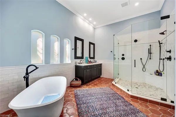 a bathroom with a sink a toilet a mirror and shower