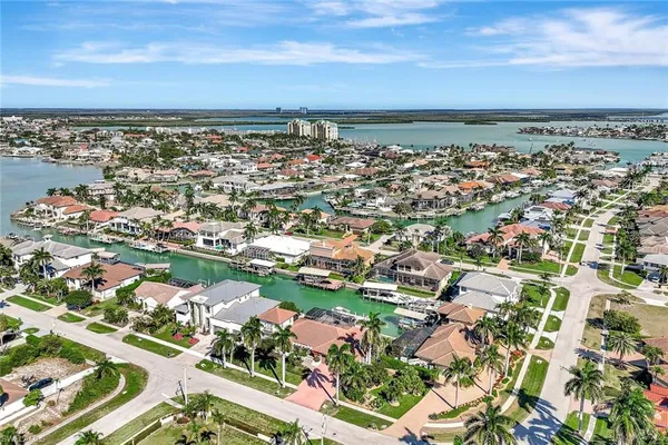 an aerial view of a house with outdoor space and lake view
