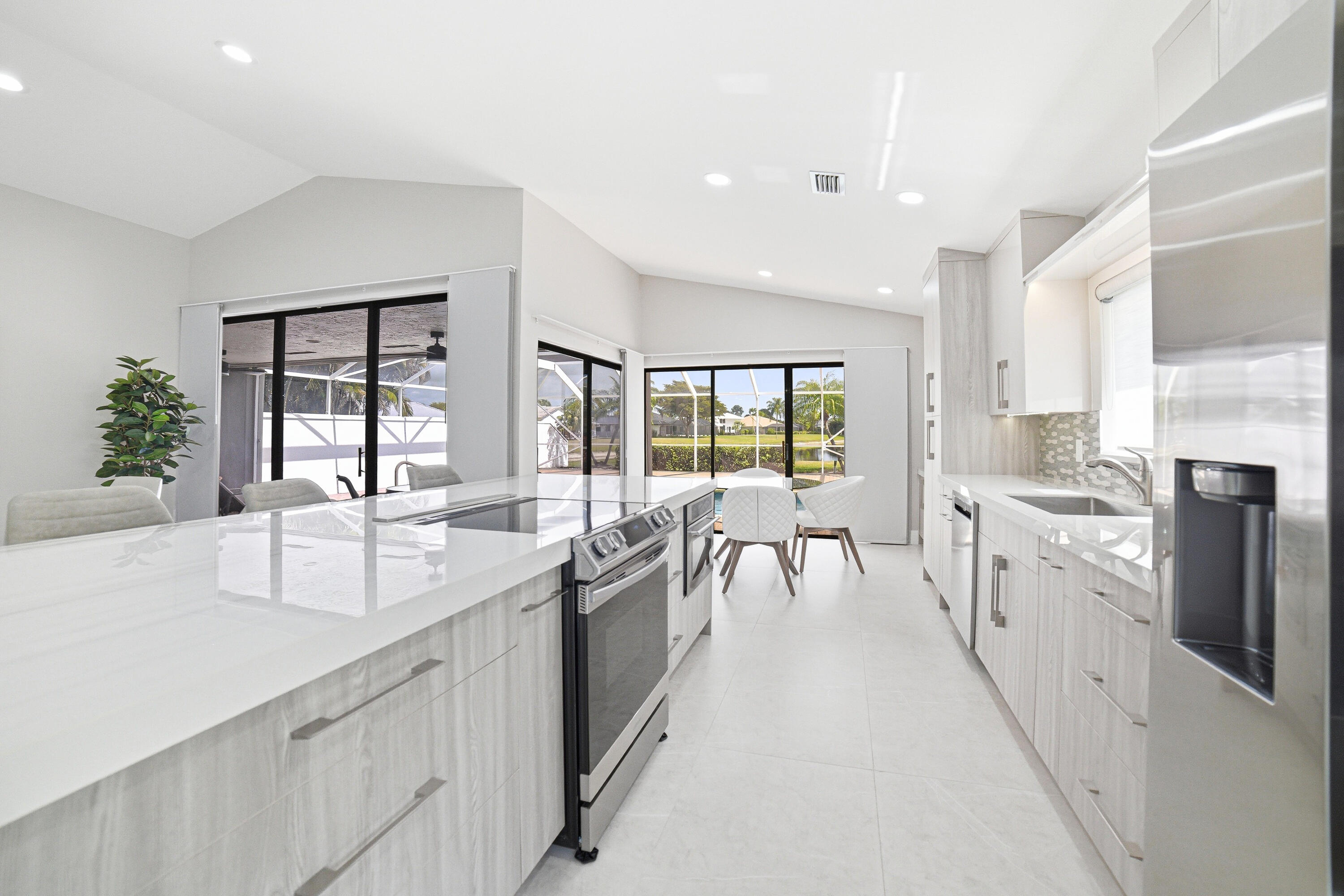 10861 White Aspen Lane Boca Raton, FL 33428 - Photo 16 of 70 a large white kitchen with lots of counter space a sink and appliances