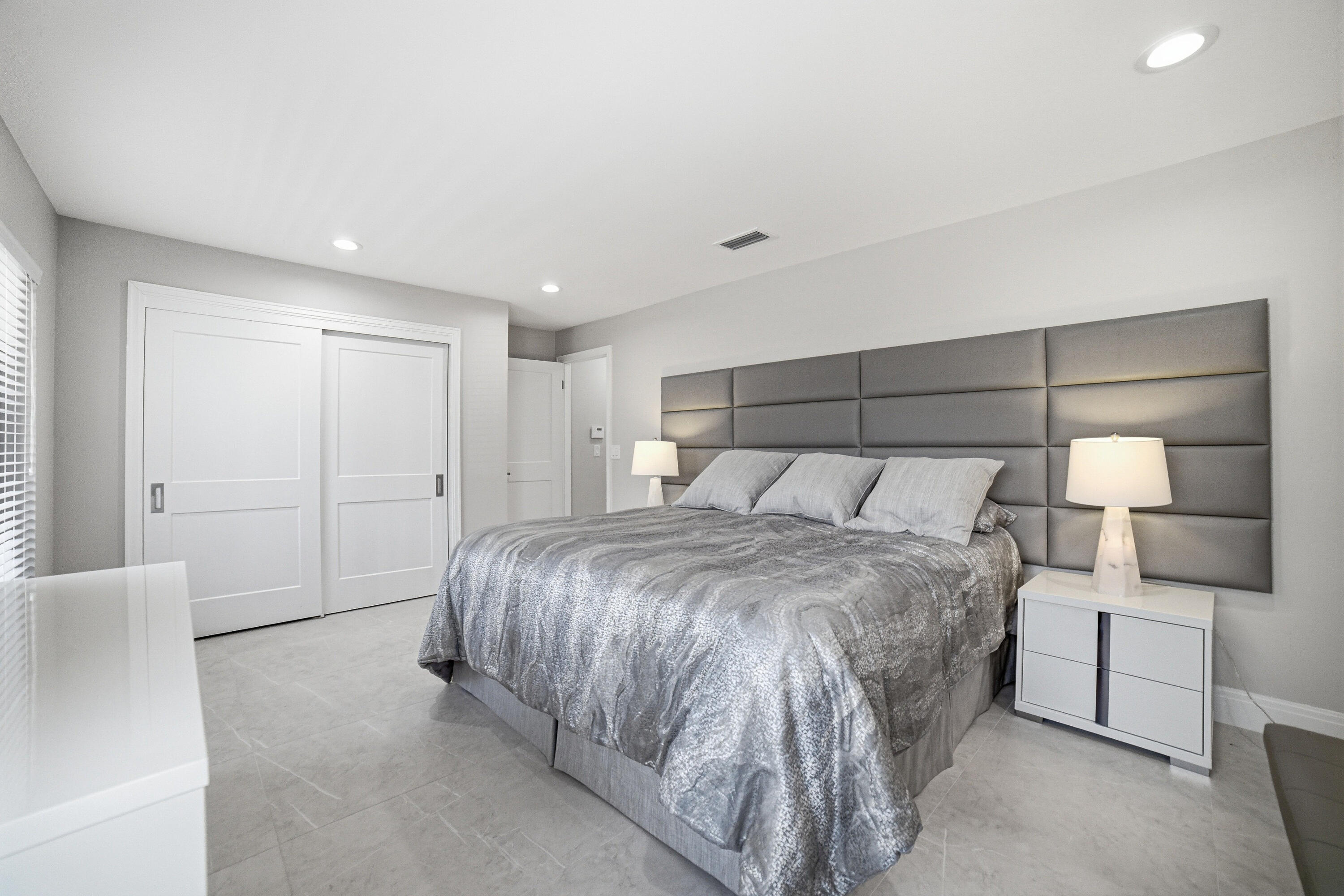 10861 White Aspen Lane Boca Raton, FL 33428 - Photo 25 of 70 a bedroom with a bed and a night stand