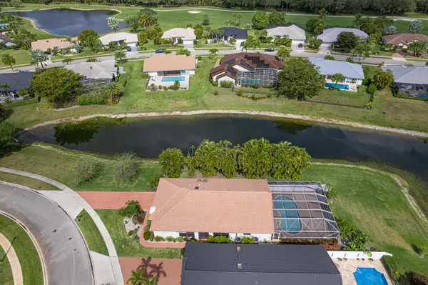 an aerial view of residential houses with outdoor space and river