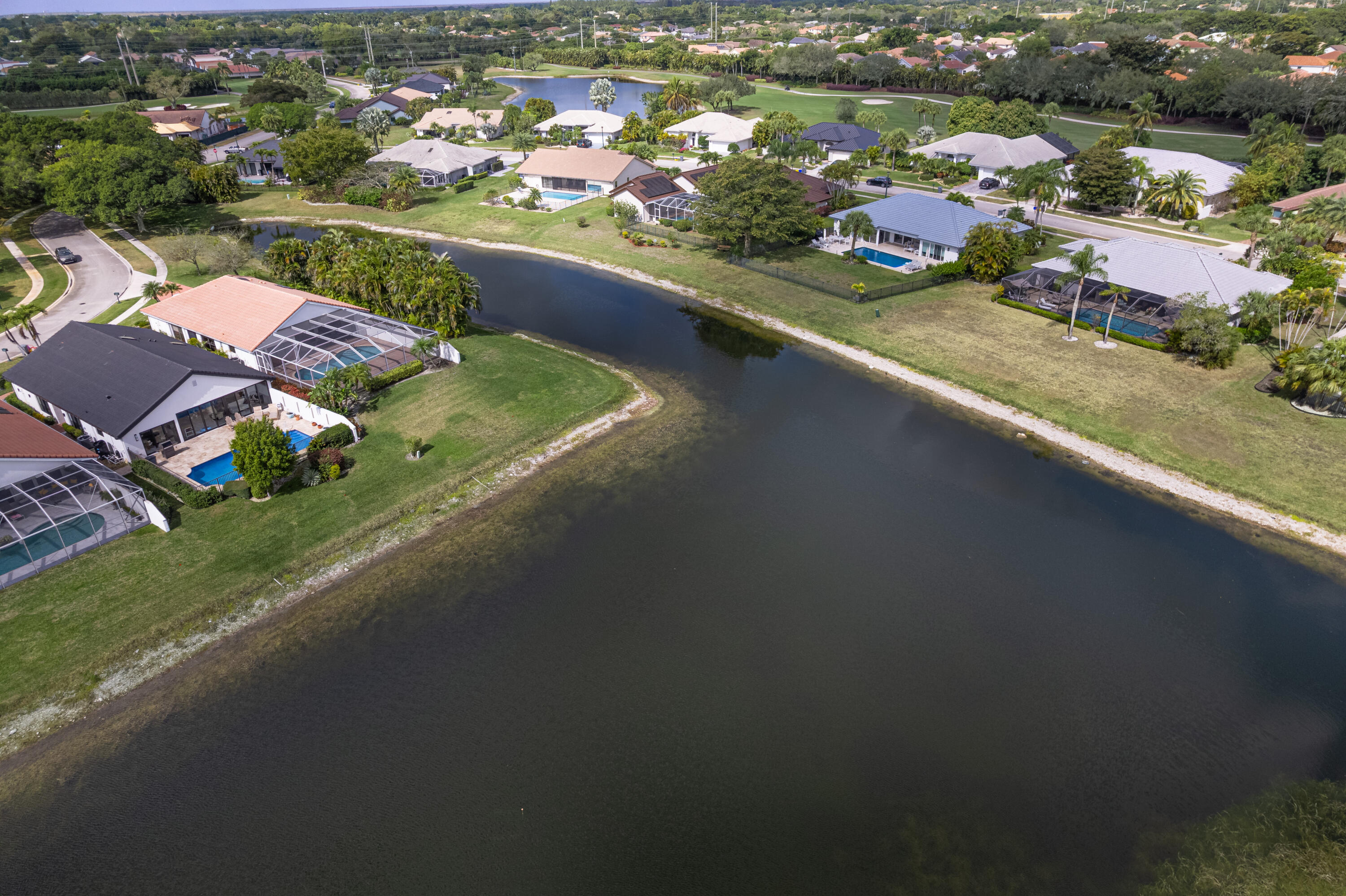 10861 White Aspen Lane Boca Raton, FL 33428 - Photo 47 of 70 an aerial view of residential houses with outdoor space and river