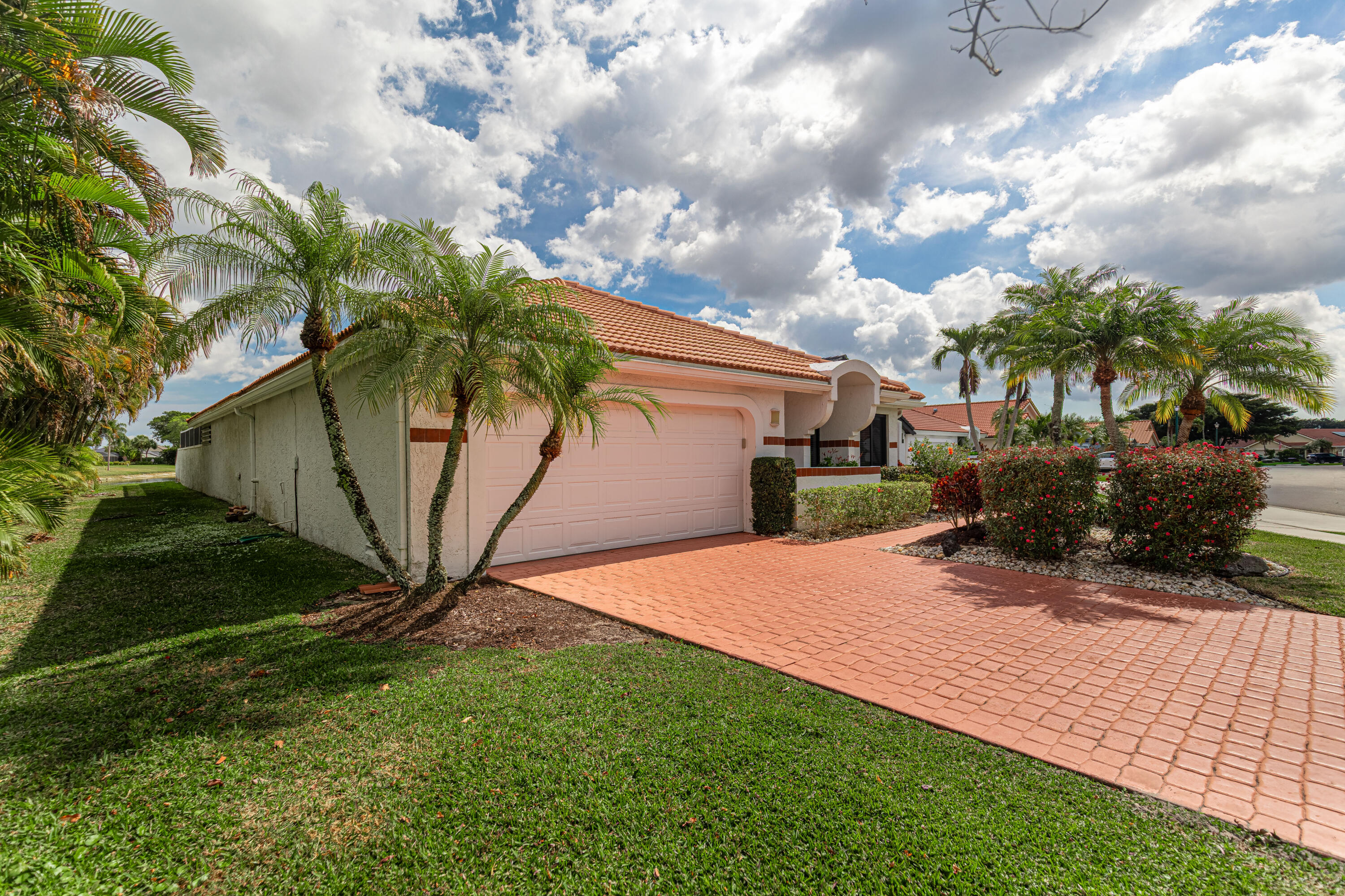 10861 White Aspen Lane Boca Raton, FL 33428 - Photo 7 of 70 a view of a backyard with plants and a large tree