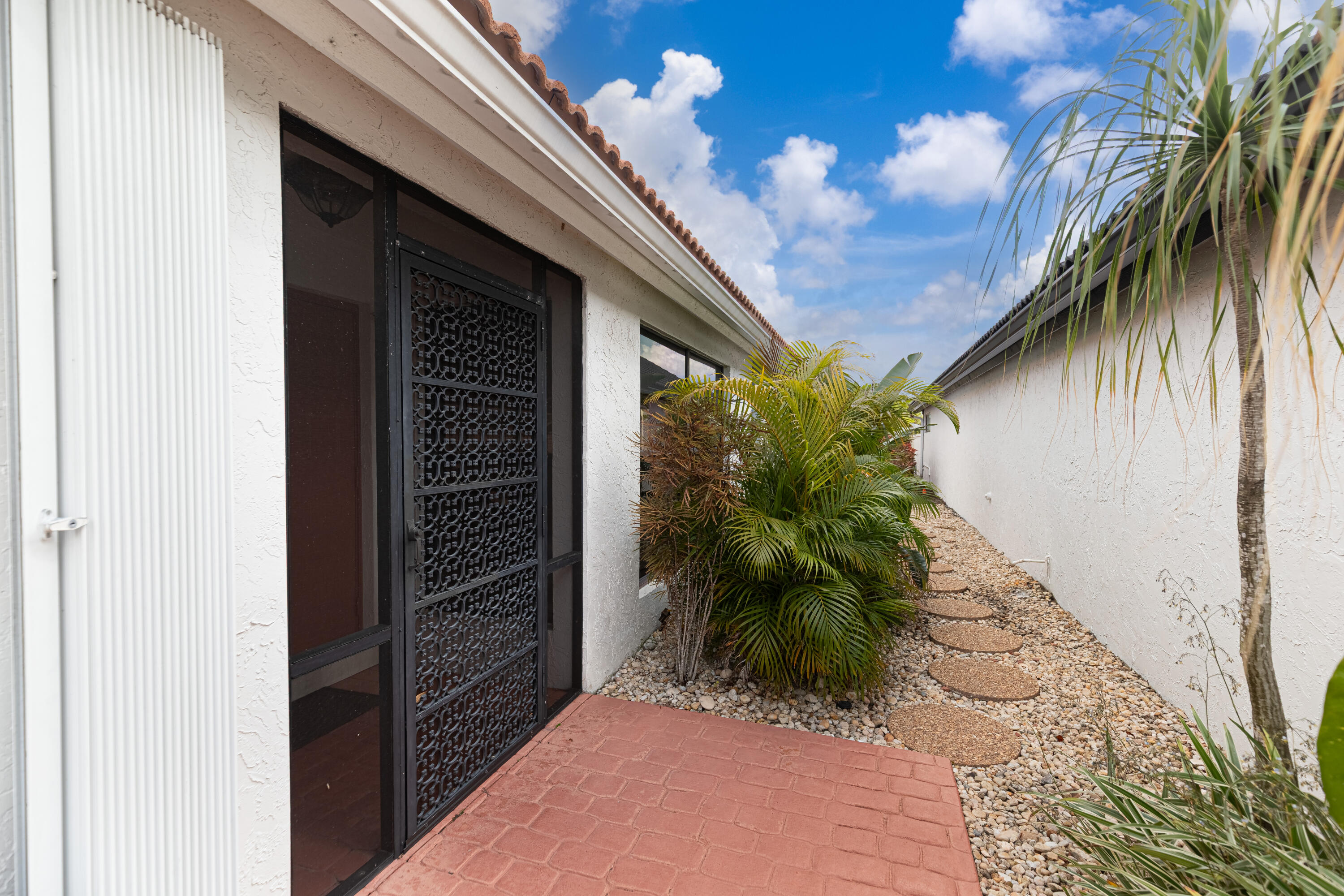 10861 White Aspen Lane Boca Raton, FL 33428 - Photo 9 of 70 a couple of potted plants in front of door