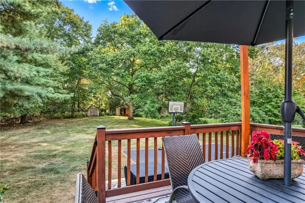 a view of a wooden deck next to a yard