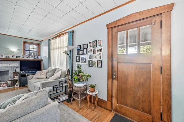 a living room with furniture a fireplace and a window