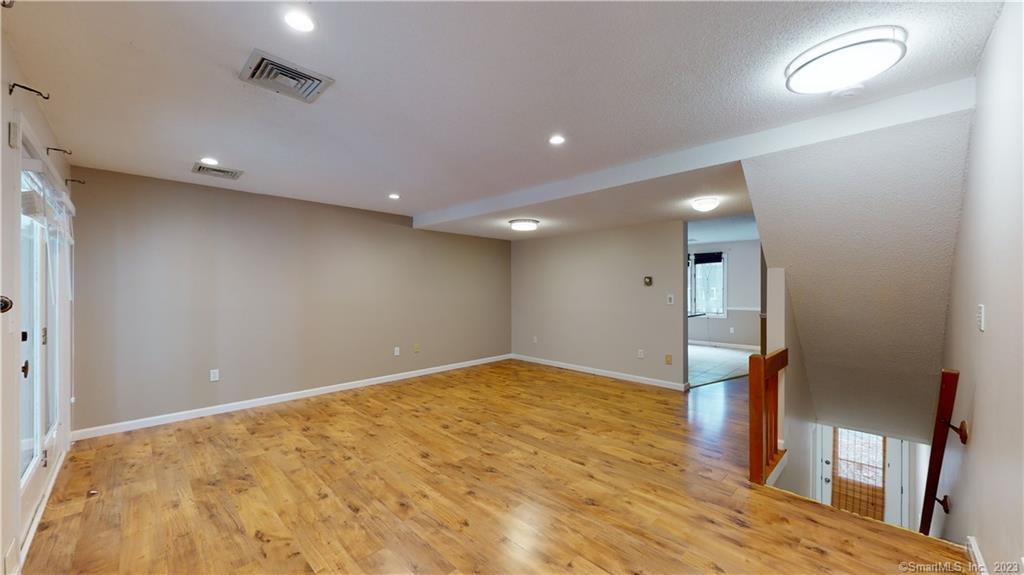 84 Songbird Lane, Unit 84 Farmington, CT 06032 - Photo 1 of 1 an empty room with wooden floor and entrance