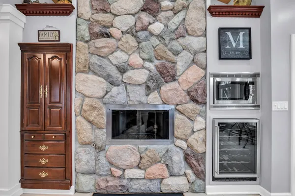 a stone fireplace with a hallway