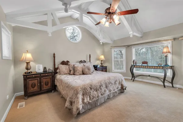 a bedroom with a bed and a chandelier