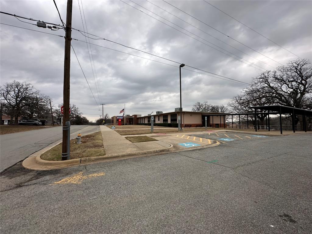 621 Munson Street Denison, TX 75021 - Photo 8 of 11 View of asphalt street featuring curbs and traffic signs