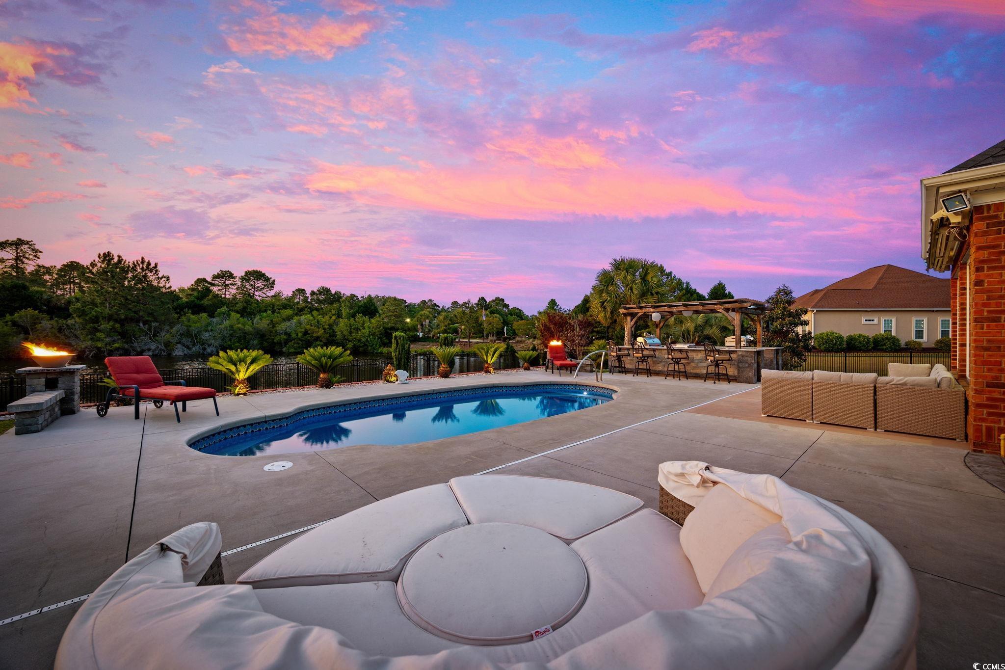 310 Babylon Pine Drive Myrtle Beach, SC 29579 - Photo 33 of 39 Patio terrace at dusk with a water view
