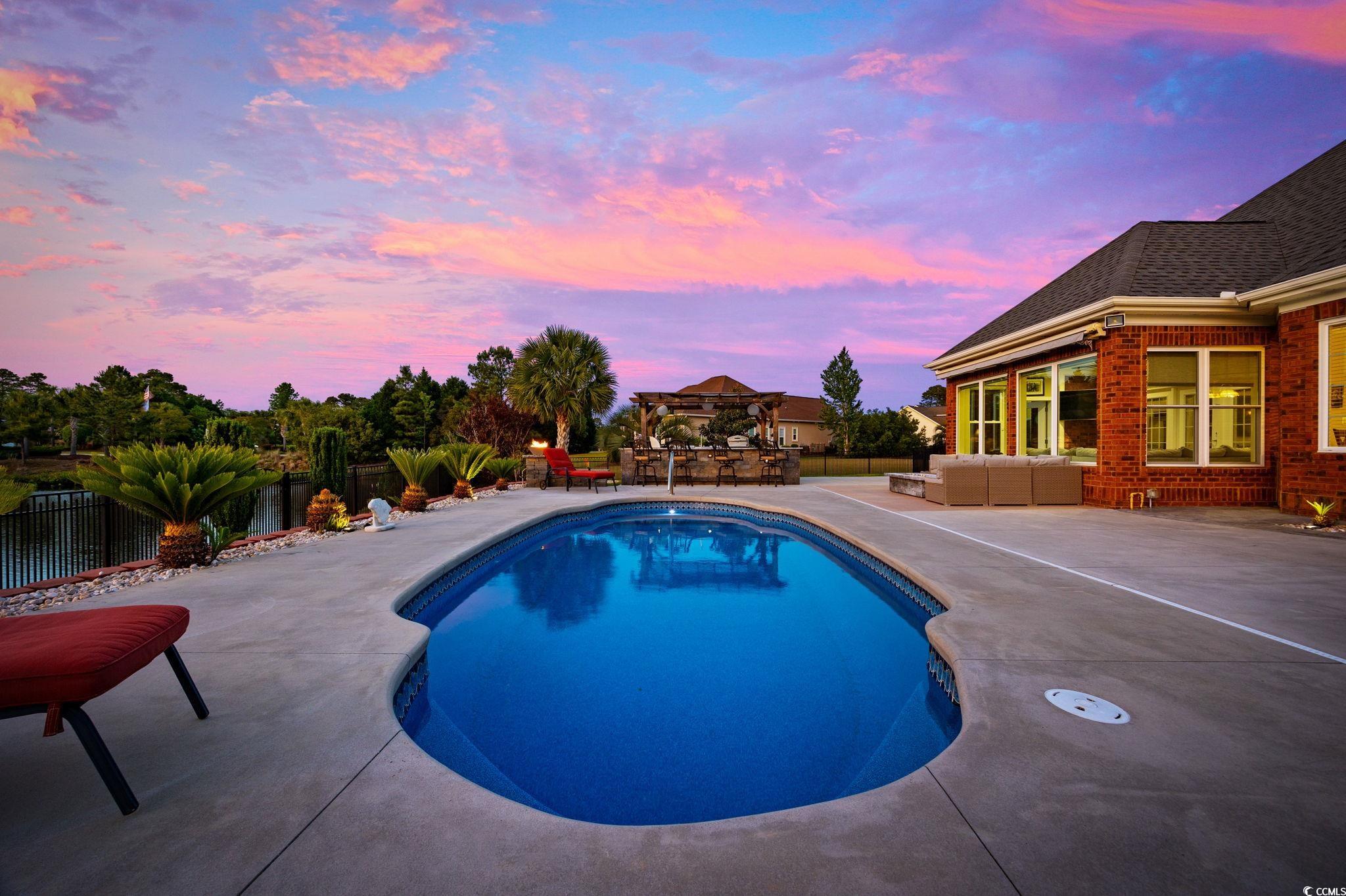310 Babylon Pine Drive Myrtle Beach, SC 29579 - Photo 34 of 39 Pool at dusk featuring outdoor lounge area and a p