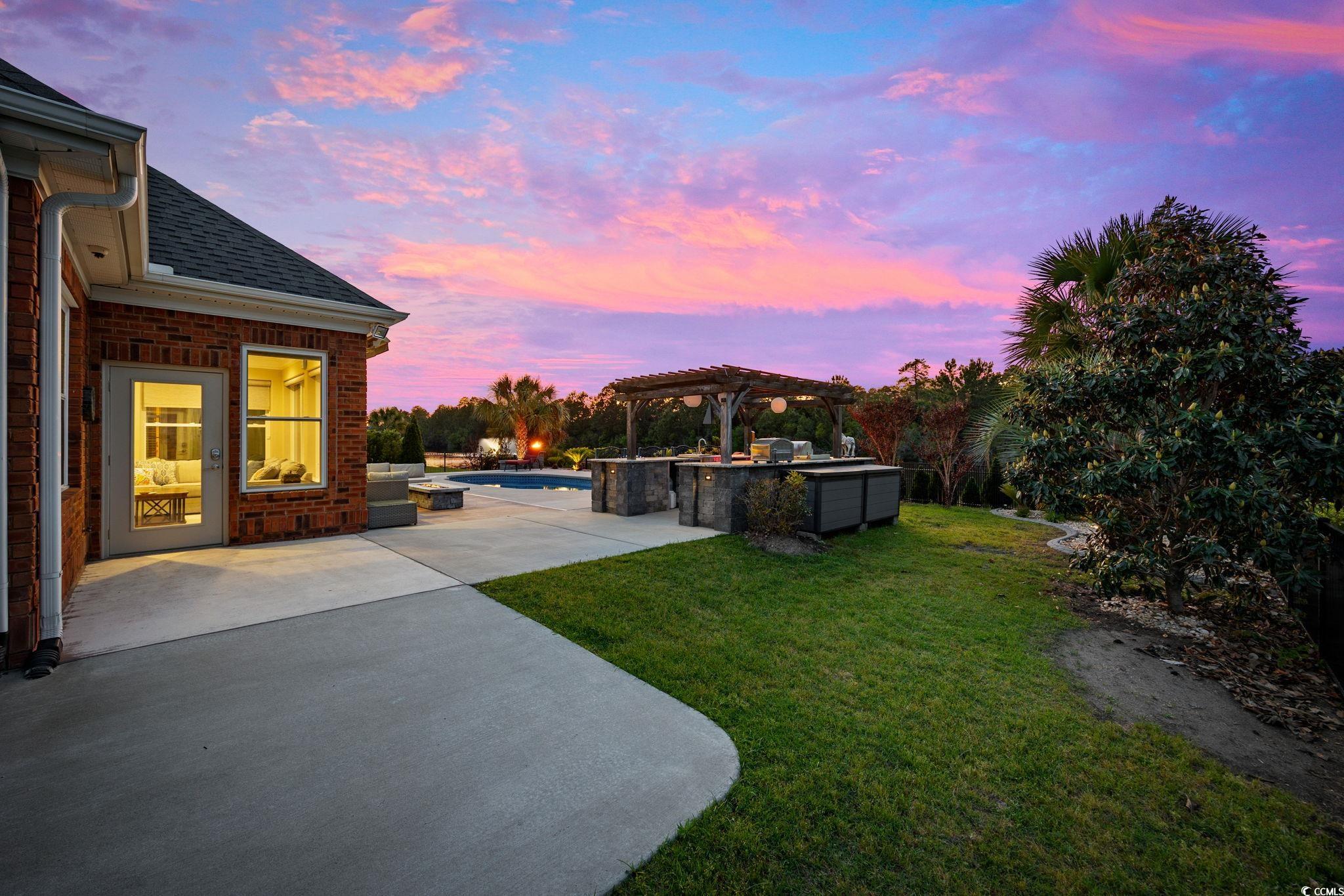310 Babylon Pine Drive Myrtle Beach, SC 29579 - Photo 35 of 39 Pool at dusk with outdoor lounge area and a patio