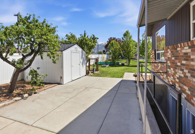 5108 South 2000th Street West Roy, UT 84067 - Photo 49 of 61 Fenced backyard featuring a storage shed