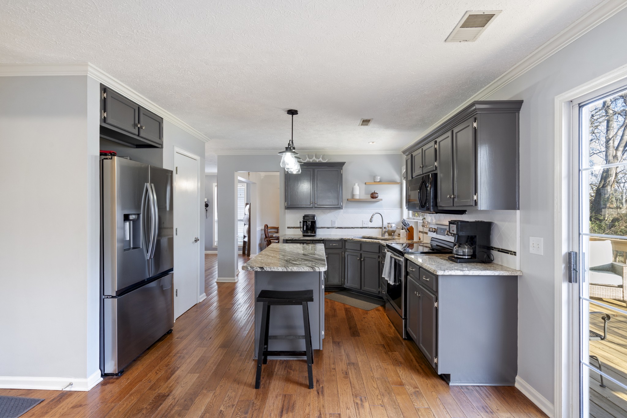 131 Deer Ridge Lane Hendersonville, TN 37075 - Photo 13 of 44 a kitchen with stainless steel appliances granite countertop a refrigerator a stove top oven a sink dishwasher and white cabinets with wooden floor