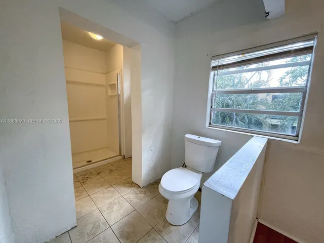 a bathroom with a toilet sink and shower