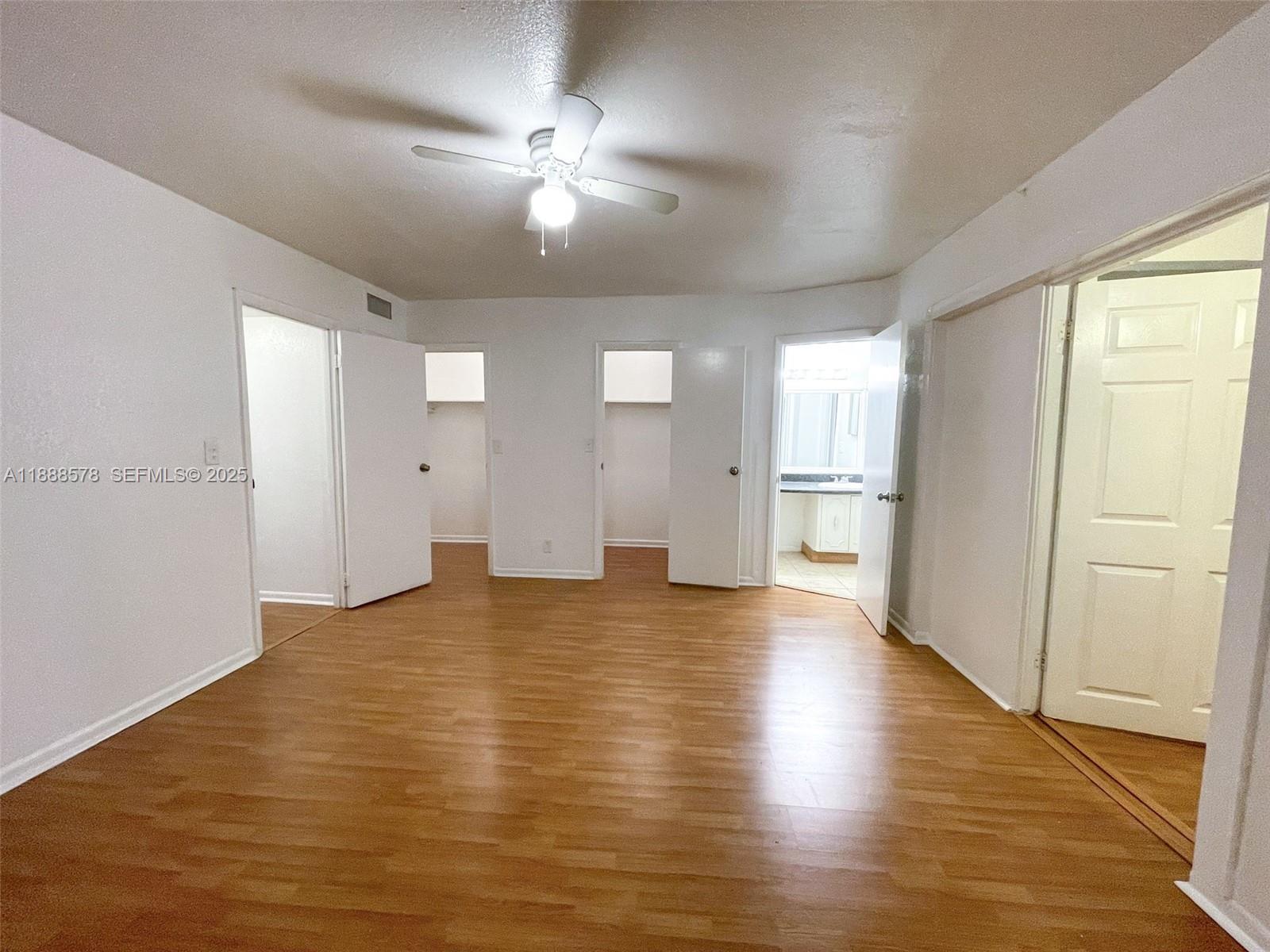 5970 Northwest 28th Street, Unit 146 Sunrise, FL 33313 - Photo 14 of 23 a view of an empty room with wooden floor and a window