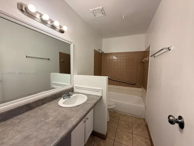 a bathroom with a sink double vanity and a mirror