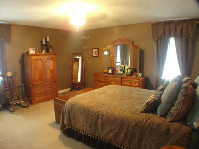 3445 New Towne Road Antioch, TN 37013 - Photo 8 of 14 a bedroom with a bed and a large mirror on dresser