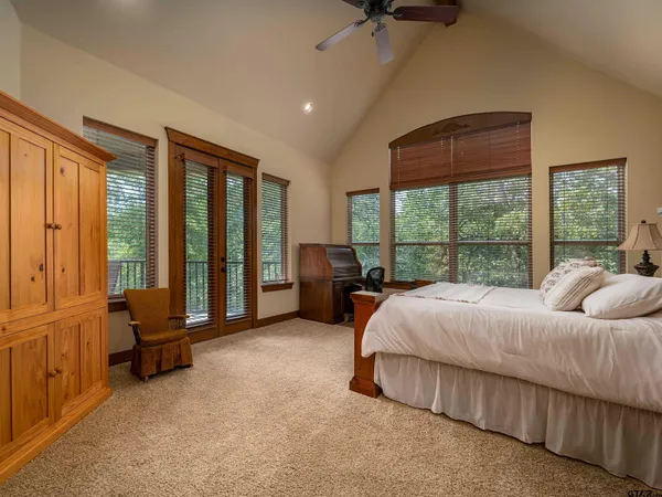 a bedroom with bed and glass window