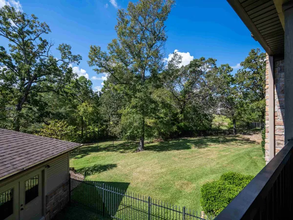 a view of a backyard with plants and a patio