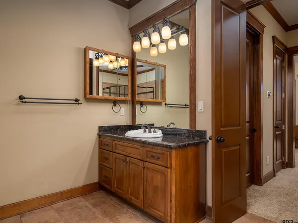 a bathroom with a granite countertop sink a mirror and a vanity