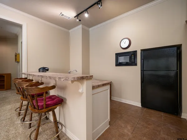 a bathroom with a refrigerator and a table