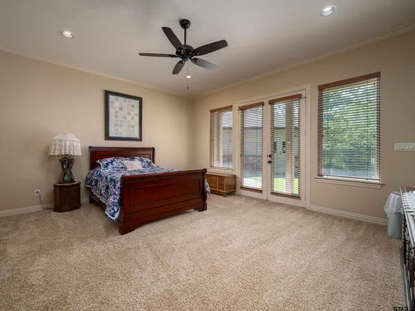 a bedroom with a bed and a large window