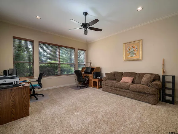 a living room with furniture and a floor to ceiling window
