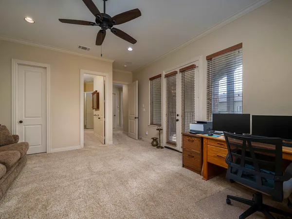 a view of a livingroom with workspace and a window