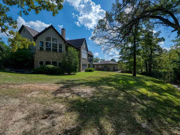 a view of a house with a yard and plants