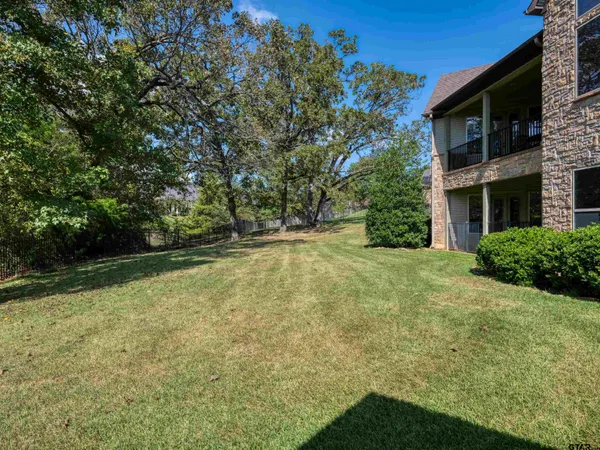 a view of a chairs and table in a swimming pool with a patio