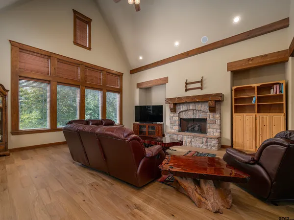 a living room with furniture flat screen tv and a fireplace