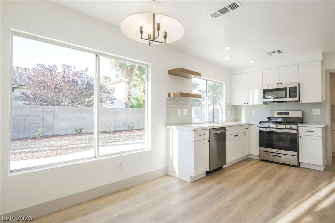 2651 Ridgewater Circle Henderson, NV 89074 - Photo 7 of 27 This bright kitchen features modern appliances, sleek cabinetry, and ample natural light, perfect for culinary adventures.
