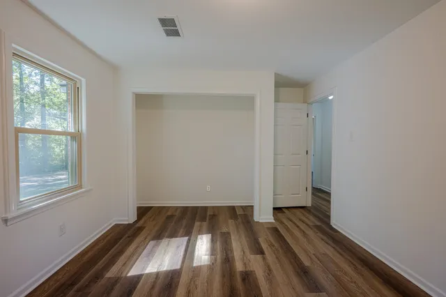 a view of a room with wooden floor cabinets and a window