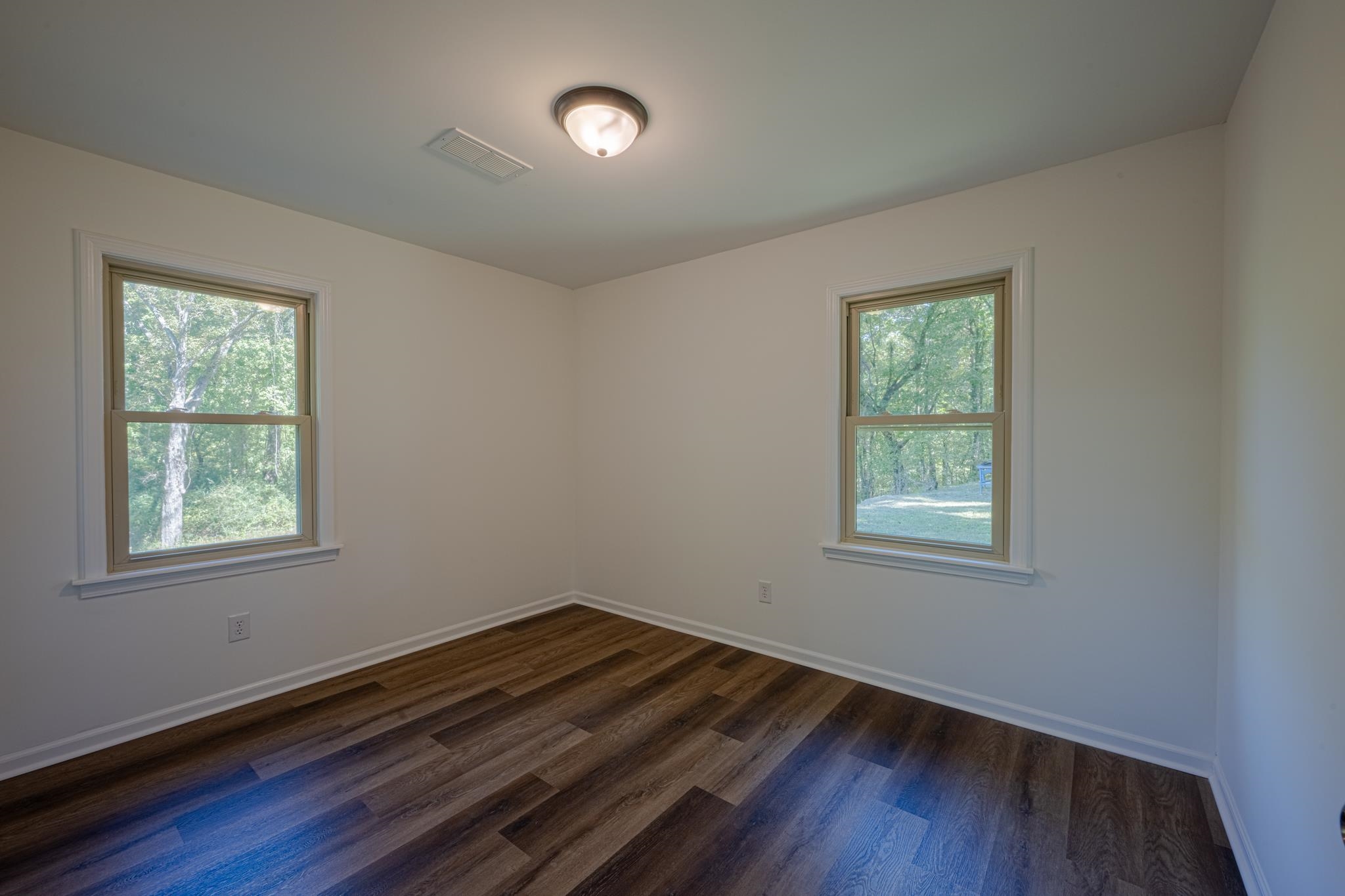 3560 Charles Bartlett Road Millington, TN 38053 - Photo 13 of 28 an empty room with wooden floor and windows