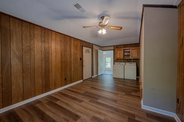 a view of empty room with wooden floor