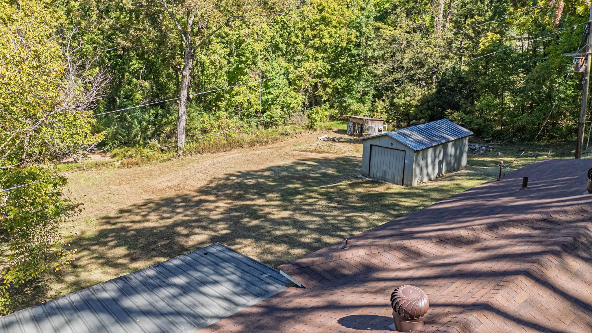 3560 Charles Bartlett Road Millington, TN 38053 - Photo 25 of 28 a view of a yard with plants and trees
