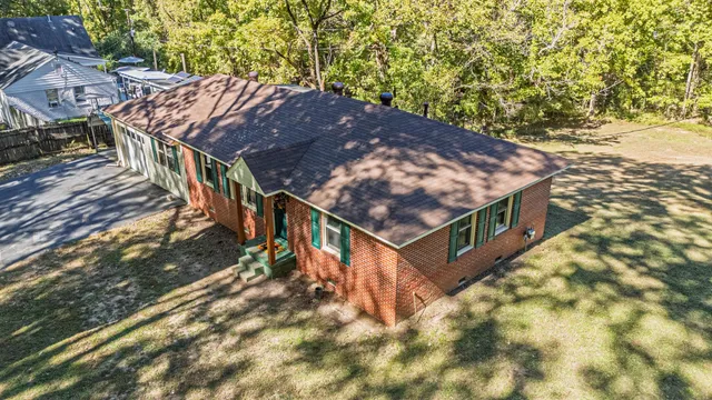 a view of a house with a yard patio and fire pit
