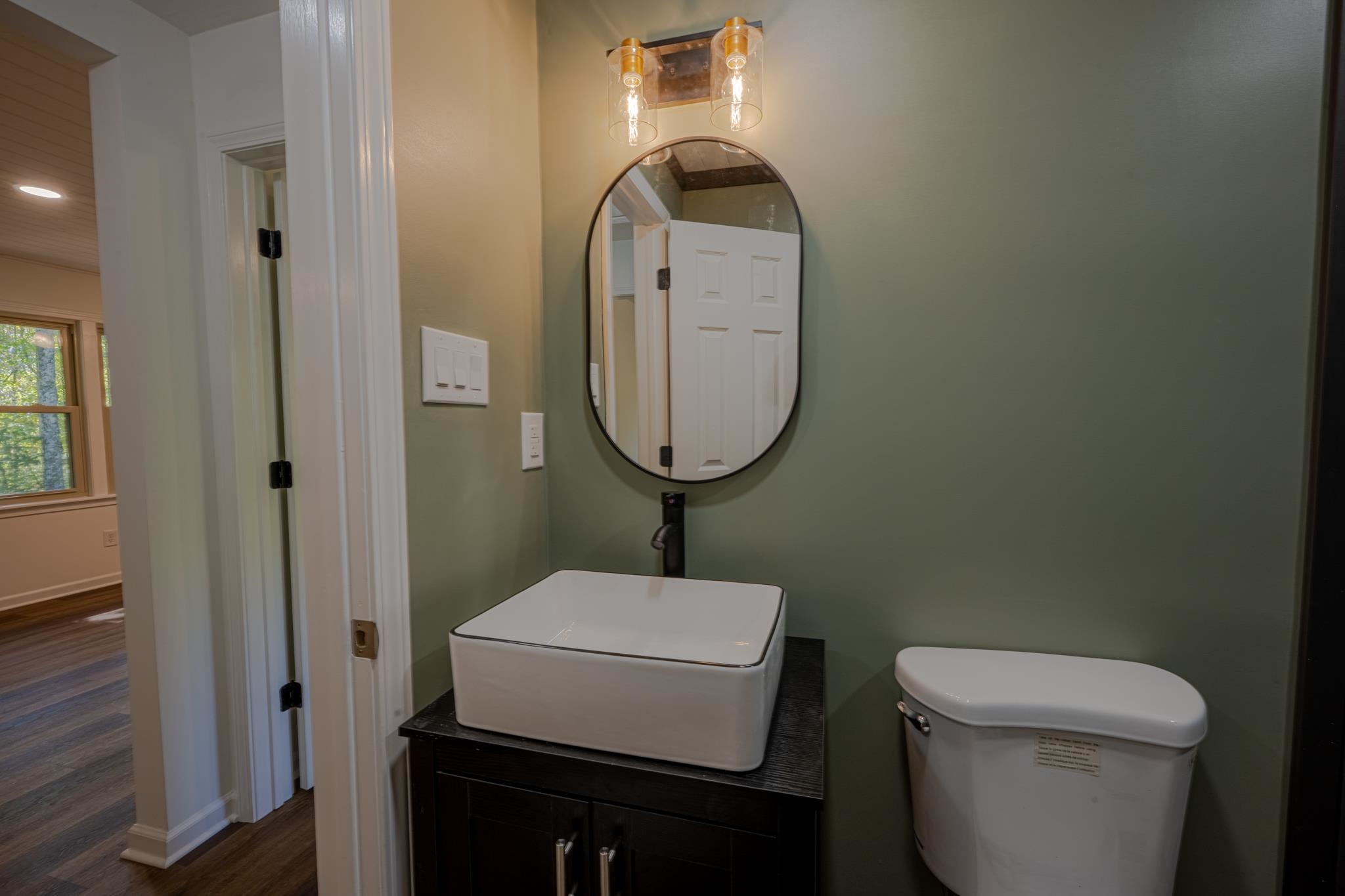 3560 Charles Bartlett Road Millington, TN 38053 - Photo 9 of 28 a bathroom with a toilet a sink and mirror