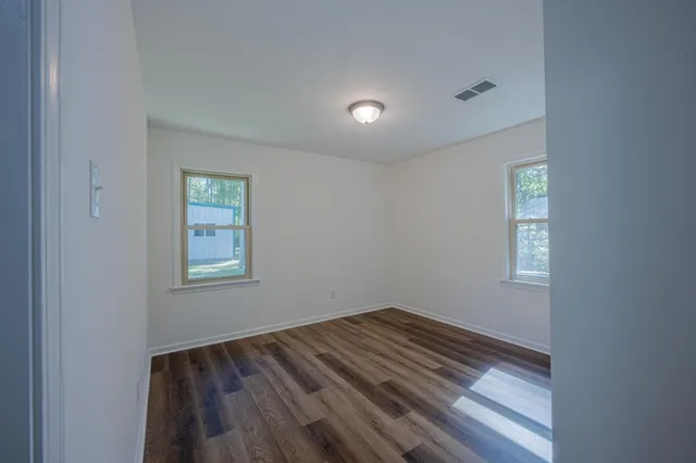 a view of room with window and hardwood floor