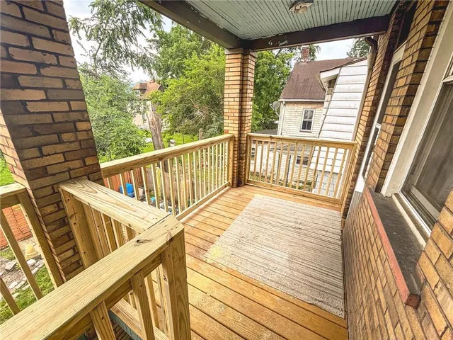 a view of balcony with wooden floor
