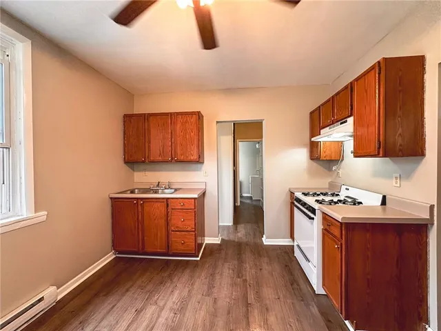 a kitchen with stainless steel appliances granite countertop a stove and a refrigerator