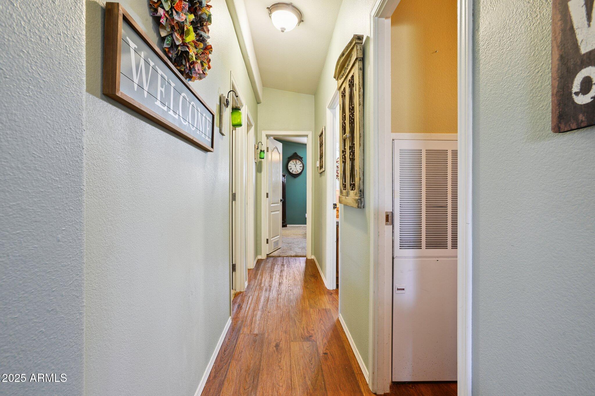 1220 Caribou Road Munds Park, AZ 86017 - Photo 15 of 42 a view of a hallway with wooden floor and staircase