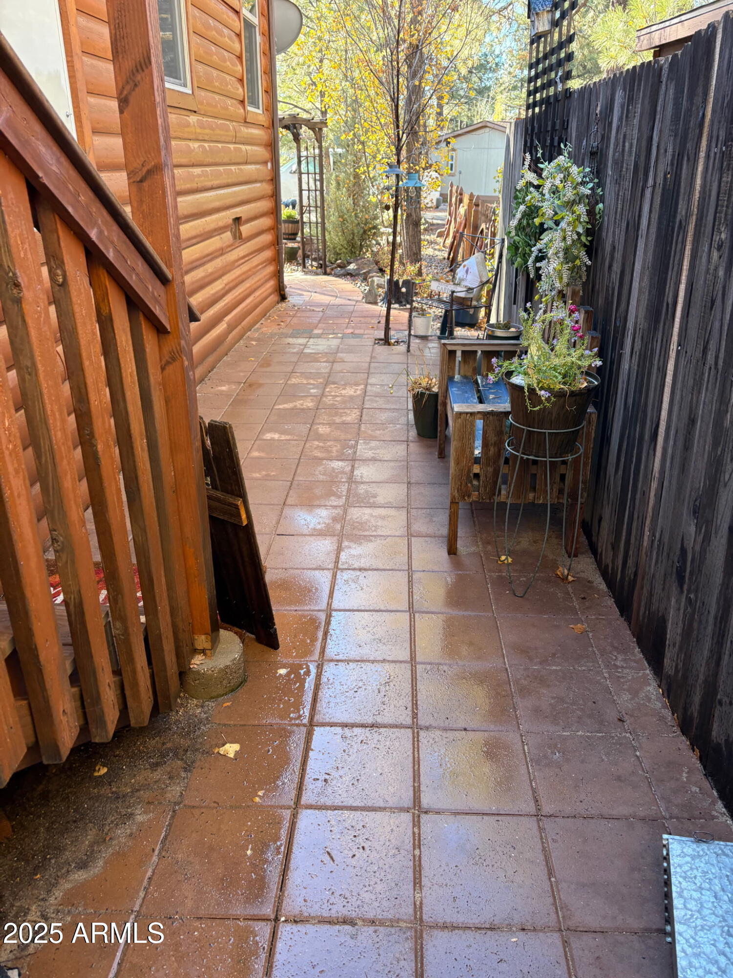 1220 Caribou Road Munds Park, AZ 86017 - Photo 4 of 42 a view of a patio with table and chairs with wooden fence and plants